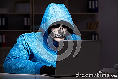 The scary hacker hacking security firewall late in office Stock Photo