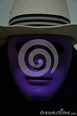 Scary hallow man in violet mask and black coat Stock Photo