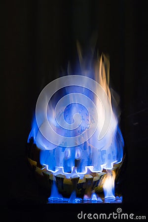 Scary halloween pumpkin burning with flame on a black background Stock Photo