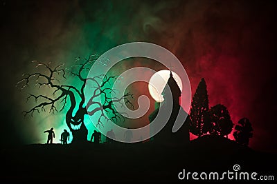 Scary view of zombies at cemetery dead tree, moon, church and spooky cloudy sky with fog, Horror Halloween concept. Stock Photo