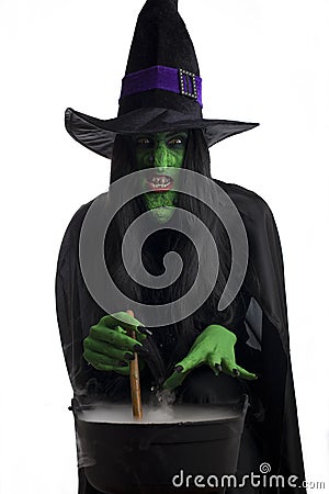 Scary witch stirring her cauldron Stock Photo