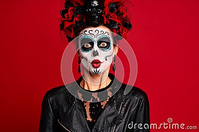 Scary young creepy lady calavera. wears artistic make-up for the feast of all the dead. Has frightened expression, wears black Stock Photo