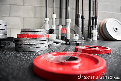 Scattered barbell weights on the floor of a gym Stock Photo