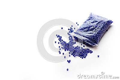 Scattered blue beads. Isolated on white background. Closeup Stock Photo