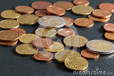 Scattered euro coins on black table close-up. Soft focus Stock Photo