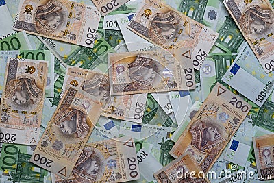 Scattered 100 euro and 200 PLN banknotes. Polish and European currency Editorial Stock Photo
