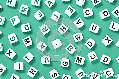 Scattered letter cubes on monochrome green background Stock Photo