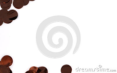 scattered metallic brown confetti on a white background with negative space for text, creating a festive and minimalistic composit Stock Photo