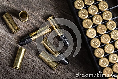 Scattering of small caliber cartridges on a wooden Stock Photo