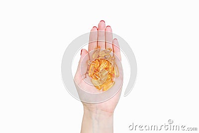 Scattering of transparent yellow pills. Handful of capsules in palm of hand, close-up, isolated on white background Stock Photo