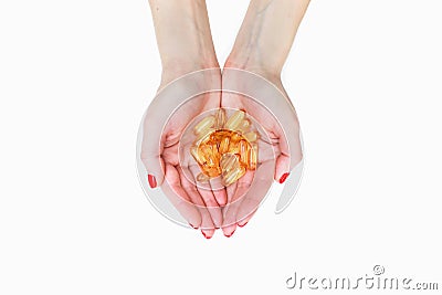 Scattering of transparent yellow pills. Handful of capsules in palm of hand, close-up, isolated on white background Stock Photo