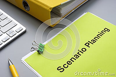 Scenario planning document near a yellow folder. Stock Photo