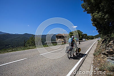 Scene of a couple of cyclists on tandem bicycle in La Garrotxa, Girona, Spain Editorial Stock Photo