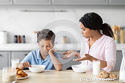 Concerned mother with an uninterested in breakfast boy Stock Photo