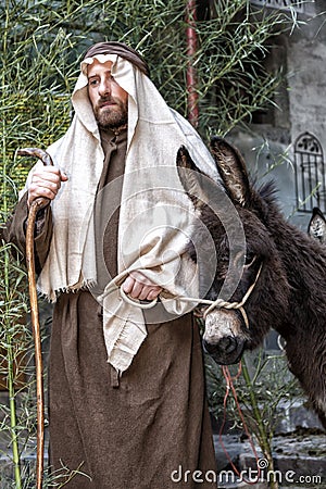 Scene of Jesus life. The flight into Egypt. Joseph and a donkey Editorial Stock Photo