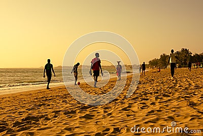 Scene of people men doing musculation sport on sand at beach during sunset in Africa, Senegal Editorial Stock Photo