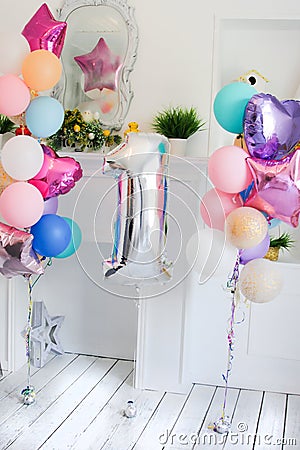 Scenery from balloons of different color and a silver sphere in the form of figure one Stock Photo