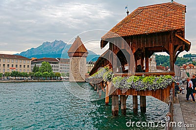 Scenery of Chapel Bridge Kapellbrucke over Reuss River in Lucerne Old Town with the Water Tower Editorial Stock Photo