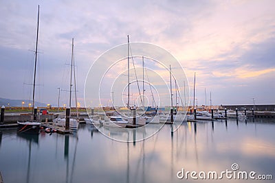 Scenery of fishing boats and yachts parking in marina under cloudy sky in I-lan, Taiwan Stock Photo