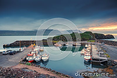 Scenery of fishing village and ship on the port and puffin colony hill by atlantic ocean in the sunset at Borgarfjordur eystri Stock Photo