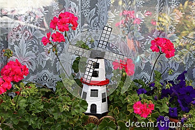 Scenery with Geraniums in the window of the House Stock Photo