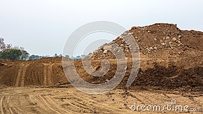 Scenery of a large mound of sand that was excavated and poured together leaving traces Stock Photo