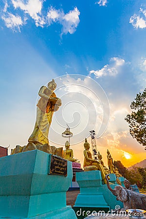 Scenery sunset behind the golden buddha in Chiang Rai Stock Photo