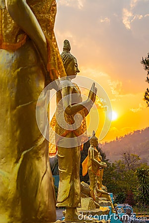 Scenery sunset behind the golden buddha in Chiang Rai Stock Photo