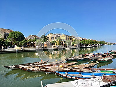 Mustard yellow building and boat on river at Hoi An ancient town, Vietnam Editorial Stock Photo