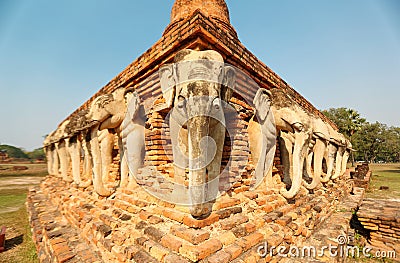 Scenery of Wat Sorasak, an ancient Buddhist Temple with elephant sculptures supporting the base of the stupa Stock Photo