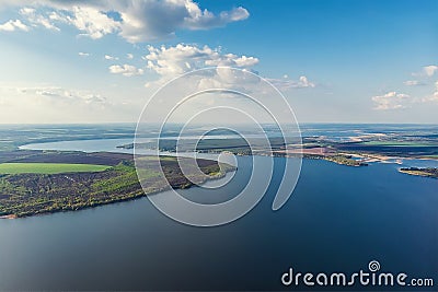 Scenic aerial panoramic landscape of Oskol river curve in eastern Europe with green forest at banks and blue cloudy sky. Natural Stock Photo