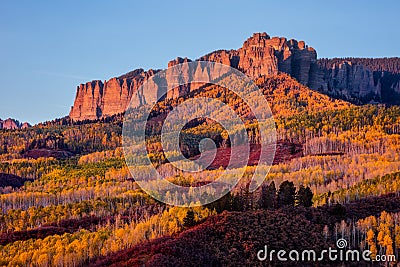 Scenic autumn landscape with aspen trees beneath Cimarron Ridge, Colorado Stock Photo