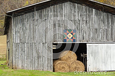 Scenic barn with hay bales and quilt design. Stock Photo