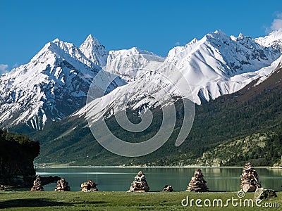 Scenic beauty of snow-capped mountains and mani stones piles Stock Photo