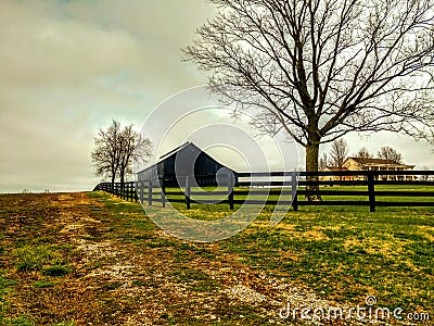 Scenic black barn and fence in Shelbyville, Kentucky Stock Photo