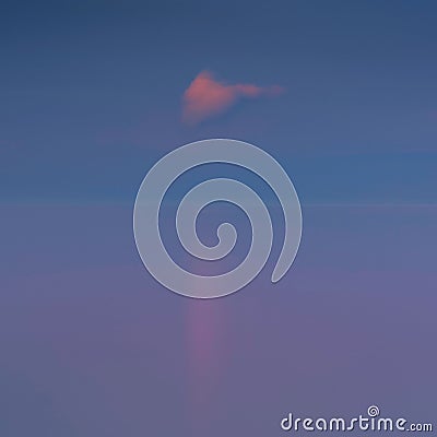 Scenic blue waterscape and horizon with a lonely sunset cloud in the sky Stock Photo