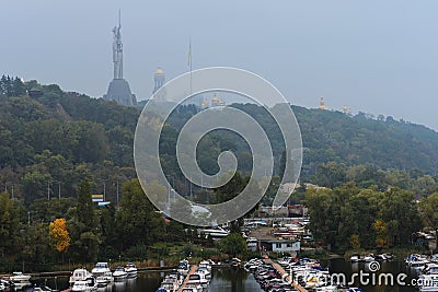 Scenic foggy morning landscape view of famous Kyiv`s hills with famous Motherland Monument and Belfry of Kyiv Pechersk Lavra Stock Photo