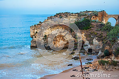 Scenic golden cliffs and emerald water, Lagos, Algarve region, Portugal Stock Photo