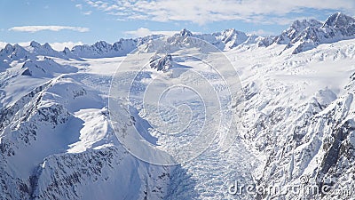 Scenic Helicopter ride over the Franz Josef Glacier and Fox Glacier with deep crevasses and snow during winter in New Zealand. Stock Photo