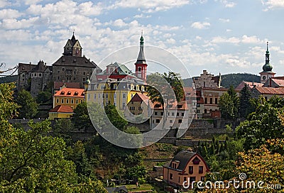 Scenic landscape view of ancient Loket Castle with colorful buildings by summer sunny day. Bohemia, Sokolov, Karlovarsky Region Stock Photo