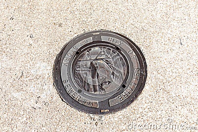 scenic metal sewer with emblem of the city of Bellaire near Houston, USA Editorial Stock Photo