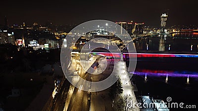 Scenic nighttime view of Belgrade Branko bridge over water, with cars seen driving across Stock Photo