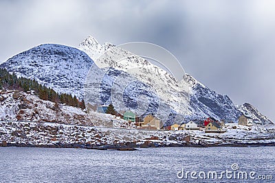 Scenic Picturesque Lofoten Islands with Colorful Small Houses Against Snowy Mountains in Background At Spring Time Stock Photo