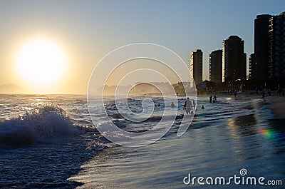 Scenic shot of beach with sea waves in Barra da Tijuca at sunset, Rio de Janerio Stock Photo