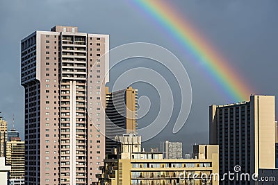 Scenic shot of a rainbow behind a series of modern buildings Stock Photo