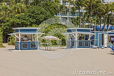 Scenic sight of two service kiosks positioned across from hotel on sandy shores of Miami Beach. Editorial Stock Photo
