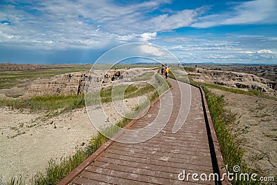Tourists hike along the boardwalk to the Big Badlands Overlook in Badlands National Park Editorial Stock Photo
