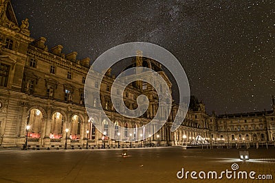 Scenic starry night sky above the Parisian Louvre Palace Editorial Stock Photo