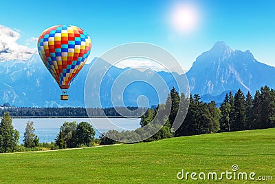 Scenic summer landscape with hot air balloon, lake and mountains Stock Photo