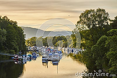 Scenic sunset view of Balloch harbour near Loch Lomond with floating boats reflected in river Leven, Scotland, United Kingdom. Editorial Stock Photo